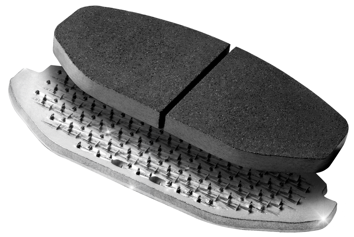 A NUCAP brake pad shown deconstructed, friction material, NRS backing plate and shim