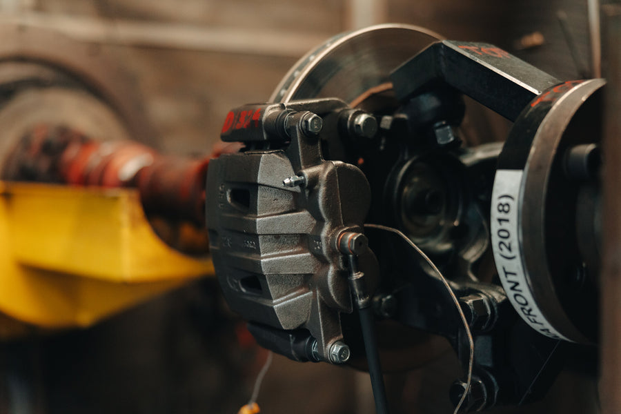 A brake caliper and rotor mounted on a test fixture